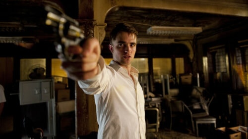Eric Packer (Robert Pattinson) avec une arme à la main dans Cosmopolis