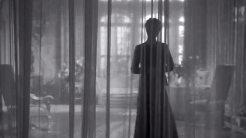 Joan Fontaine derrière le rideau dans Rebecca d'Alfred Hitchcock.